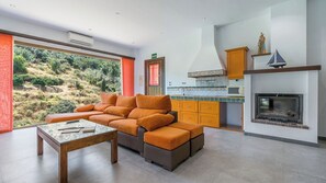 A modern living room with a sofa, a coffee table, and a fireplace.