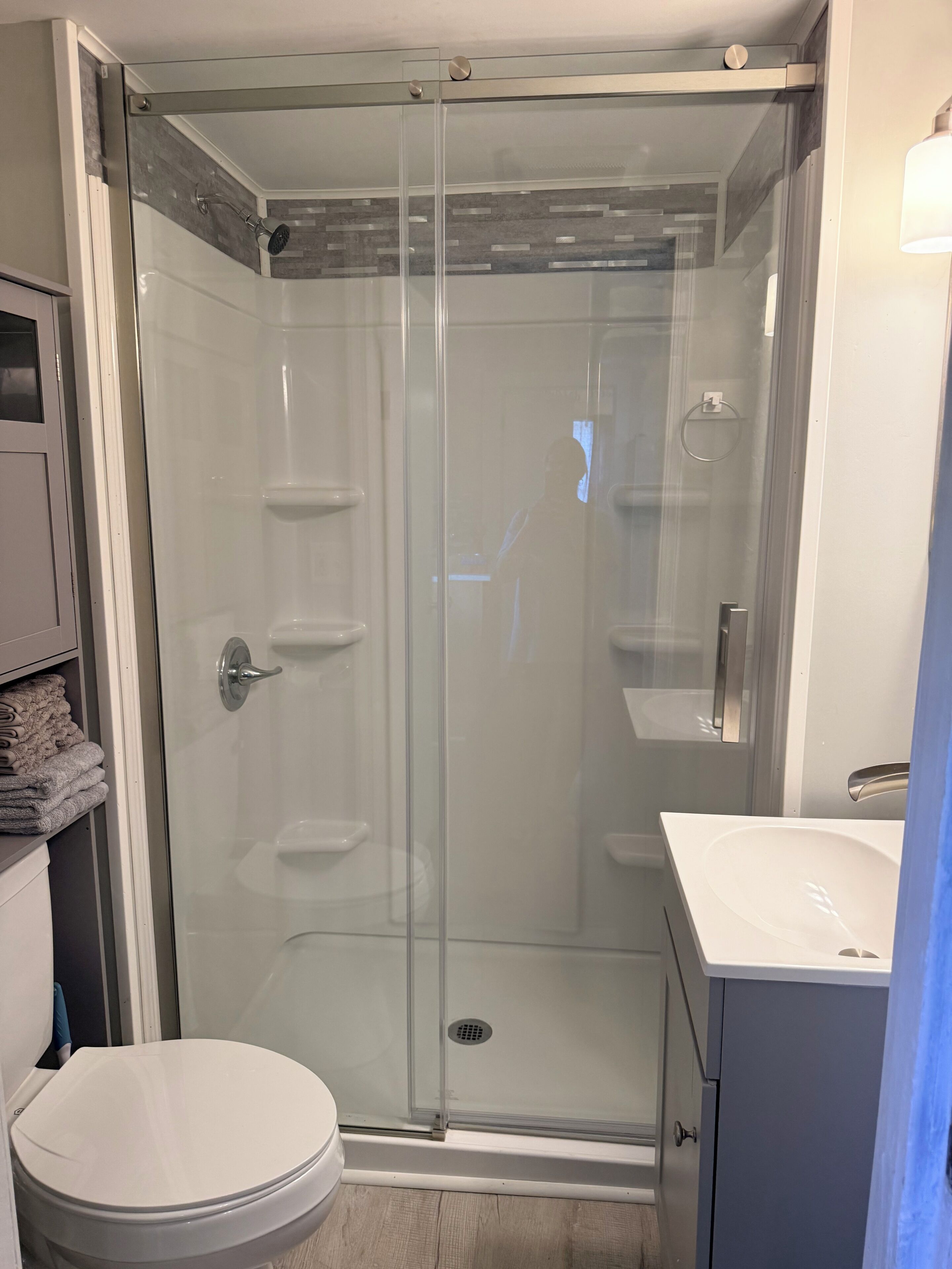 Shower, hair dryer, towels, toilet paper