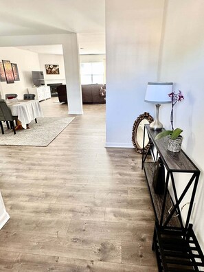 A spacious living area with a dining table, chairs, a sofa, and a coffee table. - Spacious new house in Mebane, NC (Mebane)