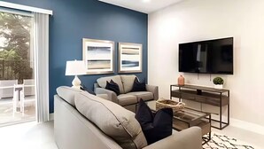 A modern living room with a sofa, a coffee table, a TV, and artwork on the wall. - Gated Resort Home, Pool & Hot Tub Near Disney (Kissimmee)