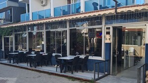 Un hotel con varios balcones, mobiliario exterior y cielo despejado.