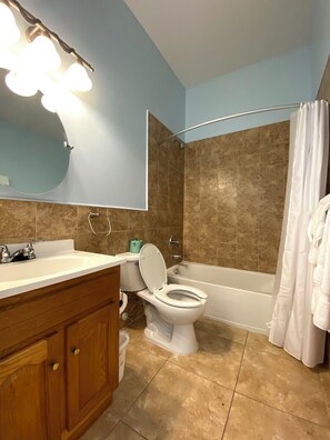 A bathroom with a toilet, sink, and bathtub. - HILLSIDE TWO BEDROOM VILLA - OCEANVIEW (Georgetown)