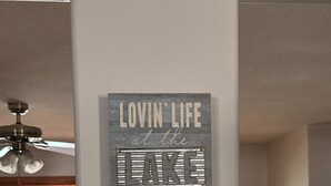 A sign with the text 'Lovin' Life at the Lake' on a wall. - Lake front sanctuary with a dock on Fairmont’s chain of lakes (Fairmont)