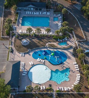 An aerial view of a resort with multiple swimming pools, sun loungers, and a building labeled 'Big Key Town.' - Pink Par-Tee Villa   Luxe Beach Getaway with Golf Cart (Murrells Inlet)