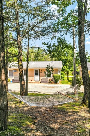 A house with a porch, a hammock, and a driveway. - Rent-A-Lake Resort at Hideaway Resort (Galena)