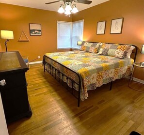 A bedroom with a bed, a desk, a chair, and a ceiling fan. - Mackey Park Retreat! (Lubbock)