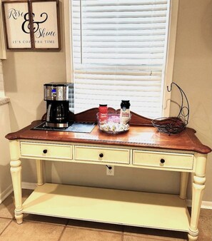 A kitchen counter with a coffee maker, a basket of coffee pods, and a jar of sugar. - Mackey Park Retreat! (Lubbock)