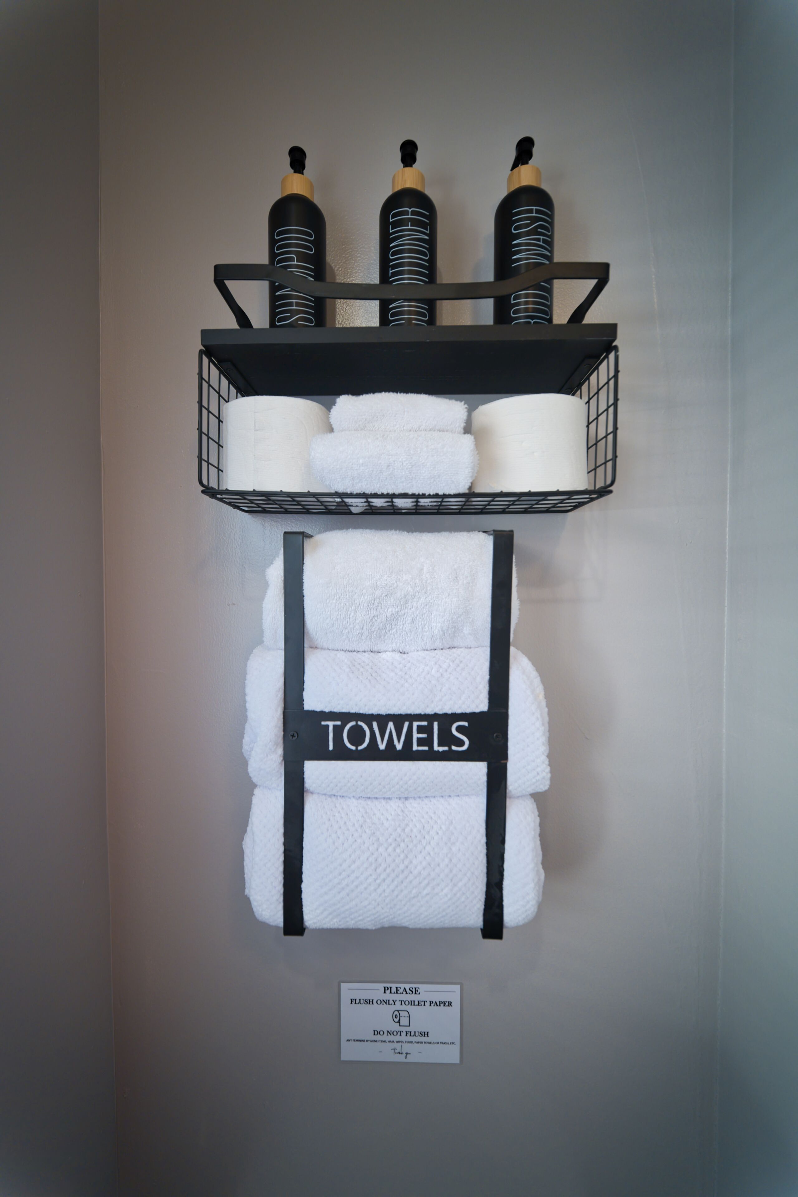 A wall-mounted shelf with toiletries and towels.