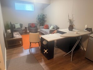 A compact living space with a kitchenette, a dining area, and seating with a view of the outdoors. - Home away from Home. Private Parking+2 Bathrooms (Calgary)