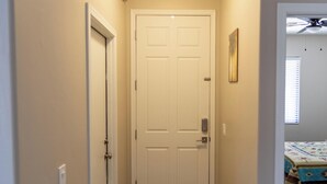 A narrow hallway with a carpeted floor leading to a white door. - Sierra Vista Hideaway / 5 minutes to Fort Huachuca (Sierra Vista)