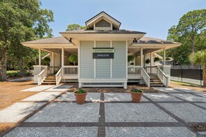 A building with a sign reading 'CENTRECOURT PAVILION' with a covered porch and steps leading to the entrance. - Lagoon-view 2BR Centre Court Villa in Palmetto Dunes with Community Pool & Tennis (Hilton Head Island)