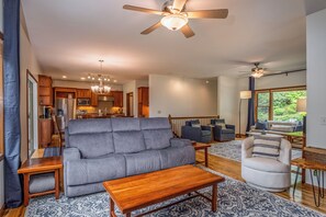 A modern living room with a grey sofa, wooden coffee table, and a patterned rug.