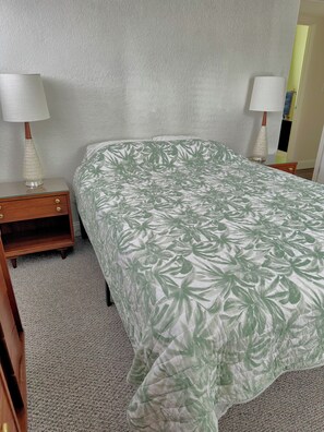 A bedroom with a bed, two bedside tables, and two lamps. - Charming Mid Century Modern Home w/office and large outdoor space (St. Petersburg)
