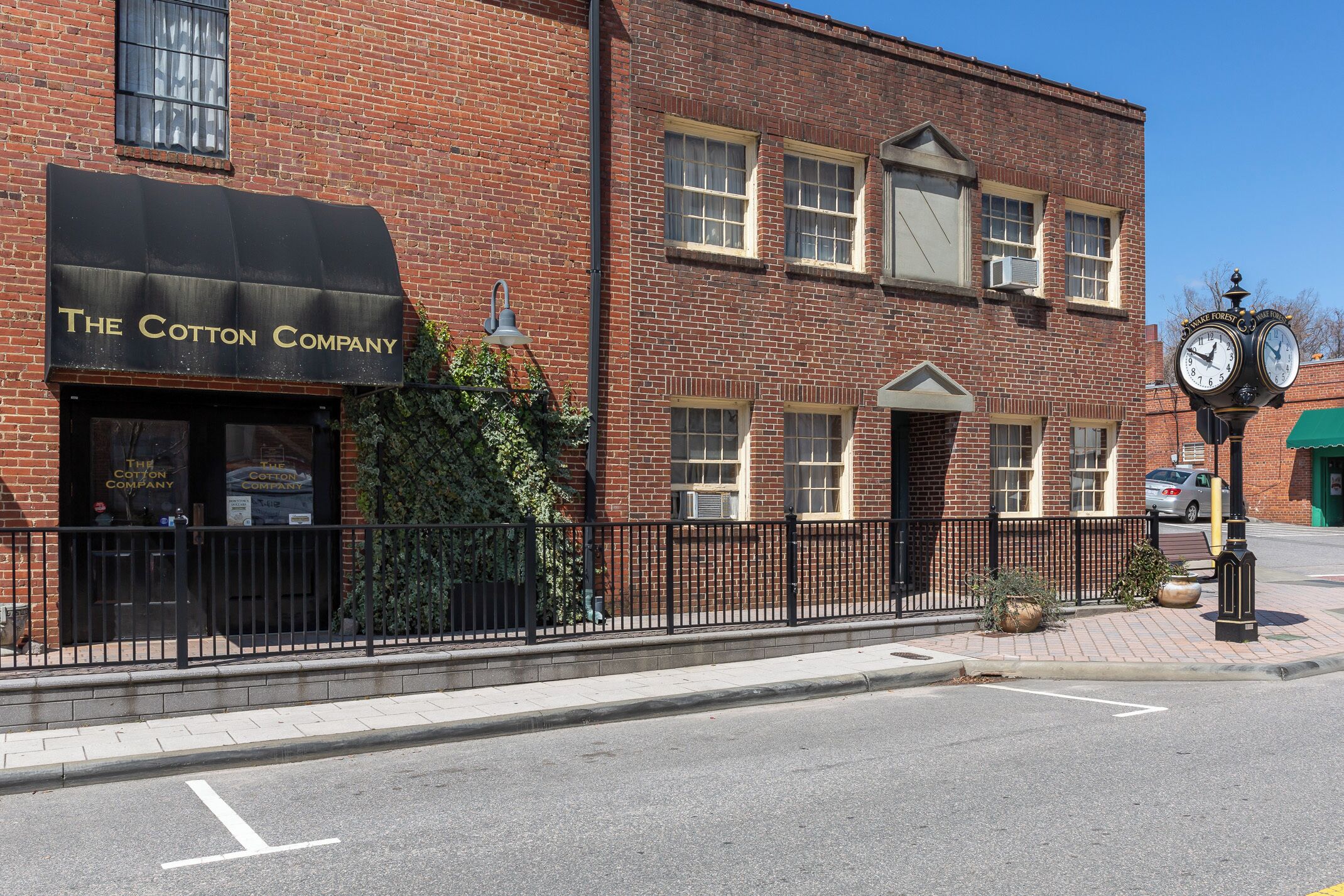Un edificio de ladrillo con toldo negro que dice 'The Cotton Company'.