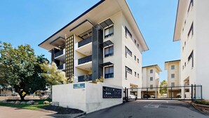 A modern apartment building with a flat roof, multiple balconies, and a gated entrance. - Peaceful 2-Bed Apartment with Private BBQ Balcony (Rosebery)