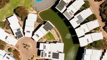 A circular layout of hotel rooms with a central swimming pool.