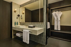 A modern bathroom with a large mirror, two sinks, and a robe rack. - Doubletree by Hilton Changsha Tianxin (Changsha)
