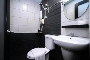 A modern bathroom with a toilet, bidet, sink, and a mirror. - Swing & Pillows @ Sunway Pyramid PJ (Petaling Jaya)