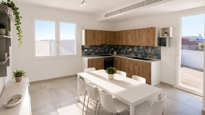 A modern kitchen with white cabinetry, a tiled backsplash, and a dining area with a white table and chairs. - Camera Osanna by Symphonya Rentals (Nardò)
