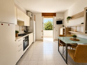 Fridge, oven, cookware/dishes/utensils, dining tables - Terrazza su Porto Selvaggio by Symphonya Rentals (Nardò)