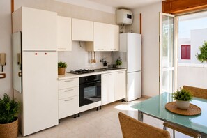 Fridge, oven, cookware/dishes/utensils, dining tables - Terrazza su Porto Selvaggio by Symphonya Rentals (Nardò)