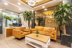 A modern living room with leather sofas, a coffee table, and potted plants. - Lai Hotel Phu Nhuan - Near Tan Dinh Church & District 1 (Ho Chi Minh City)
