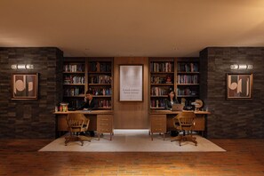 A library with two desks, bookshelves, and framed artwork on the walls. - UNWIND HOTEL & BAR OKUNIKKO (Nikko)