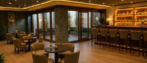 A bar area with wooden bar stools and a bar counter.