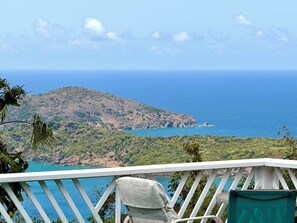 A balcony with a view of a mountainous coastline and the sea. - 3-bedroom estate in peaceful Charlotte Amalie East with AC (St. Thomas)