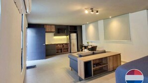 Un appartement moderne doté d’une kitchenette, d’un coin repas et d’un espace de vie.