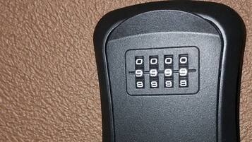 A black, rectangular object with a keypad on a textured surface.