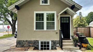 A single-story house with a gabled roof, a front door, and a small porch area.