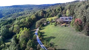 A rural property with a house surrounded by trees and a winding road. - Entire 70 acre private Ozark Mountain Retreat. Sleeping room for TEN guests! (Pelsor)