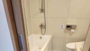A bathroom with a bathtub, toilet, and shower. - Gimhae H. Avenue (Gimhae)