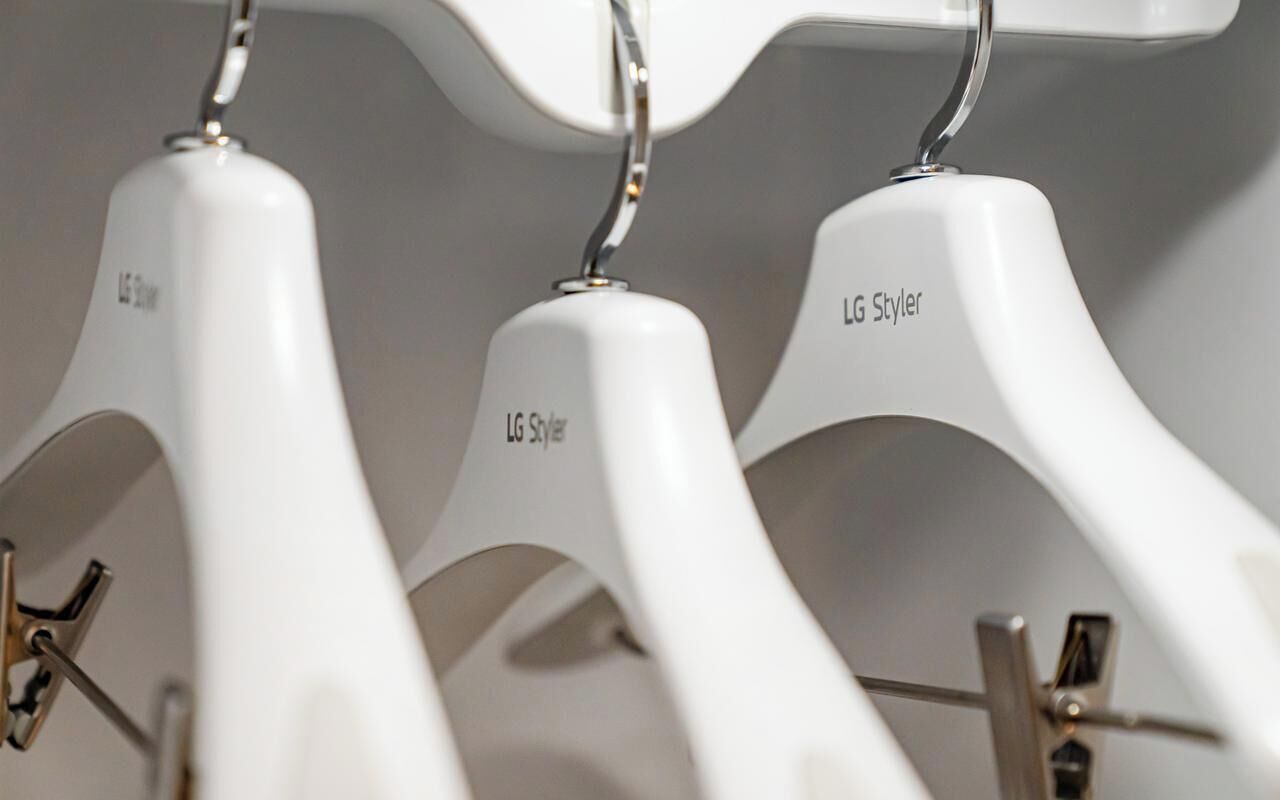 A row of white hangers with the text 'LG Styler' and 'LG Styler' visible on them.