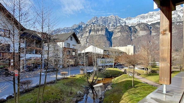 A residential area with houses, a small stream, and mountains in the background. - Walensee House & Apartments, (Unterterzen), by Interhome (Unterterzen)
