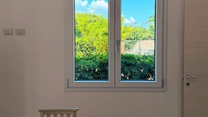A room with a window, a door, and a table. - Casa Volqart (Località Rogana I)