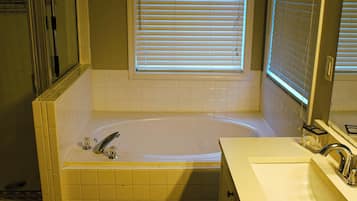 Jetted bath, hair dryer, towels, toilet paper
