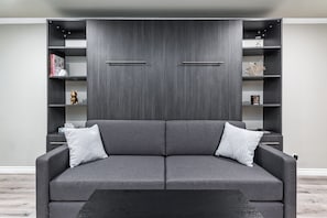 A modern living room with a grey sofa, two side tables, and a black coffee table. - SGV+Disney+Rose Bowl•King Studio near DTLA (Alhambra)