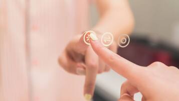 A close-up of a hand interacting with a touchscreen interface.