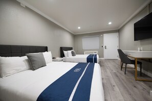 A hotel room with two beds, a desk, and a television. - SGV+Disney+Rose Bowl • Quadruple Rm near DTLA (Alhambra)