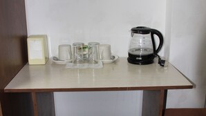 A small table with a coffee maker, several cups, and a box. - Sultan Kyzyl-Kiya (Kyzyl-Kiya)