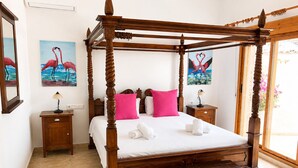 A four-poster bed with a wooden finish, two bedside tables, a nightstand, and a chest of drawers. - Private Pool Villa in El Chaparral (El Chaparral)