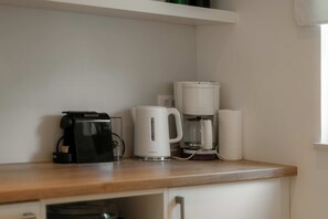 A kitchen counter with a coffee maker, a kettle, and a roll of paper towels. - Villa Lykka (100631-K1) - Kastelir (Kastelir)