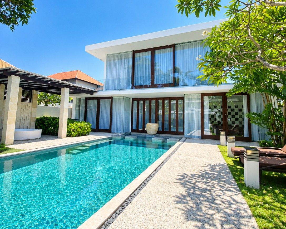 A modern two-story house with a swimming pool, a covered patio, and a well-maintained garden.