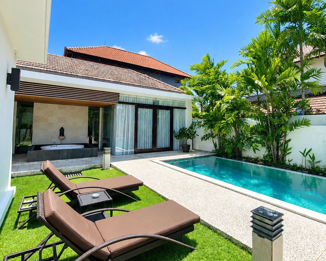 A modern house with a swimming pool, outdoor seating, and a garden.