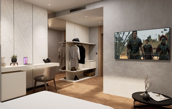 A modern hotel room with a minimalist design, featuring a desk, a chair, a wardrobe, and a large framed picture on the wall.