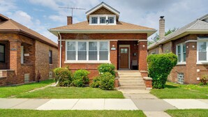 A two-story brick house with a front porch, a satellite dish, and a chimney. - Pool Table! Pet-Friendly Haven 6 Mi to Rate Field (Chicago)