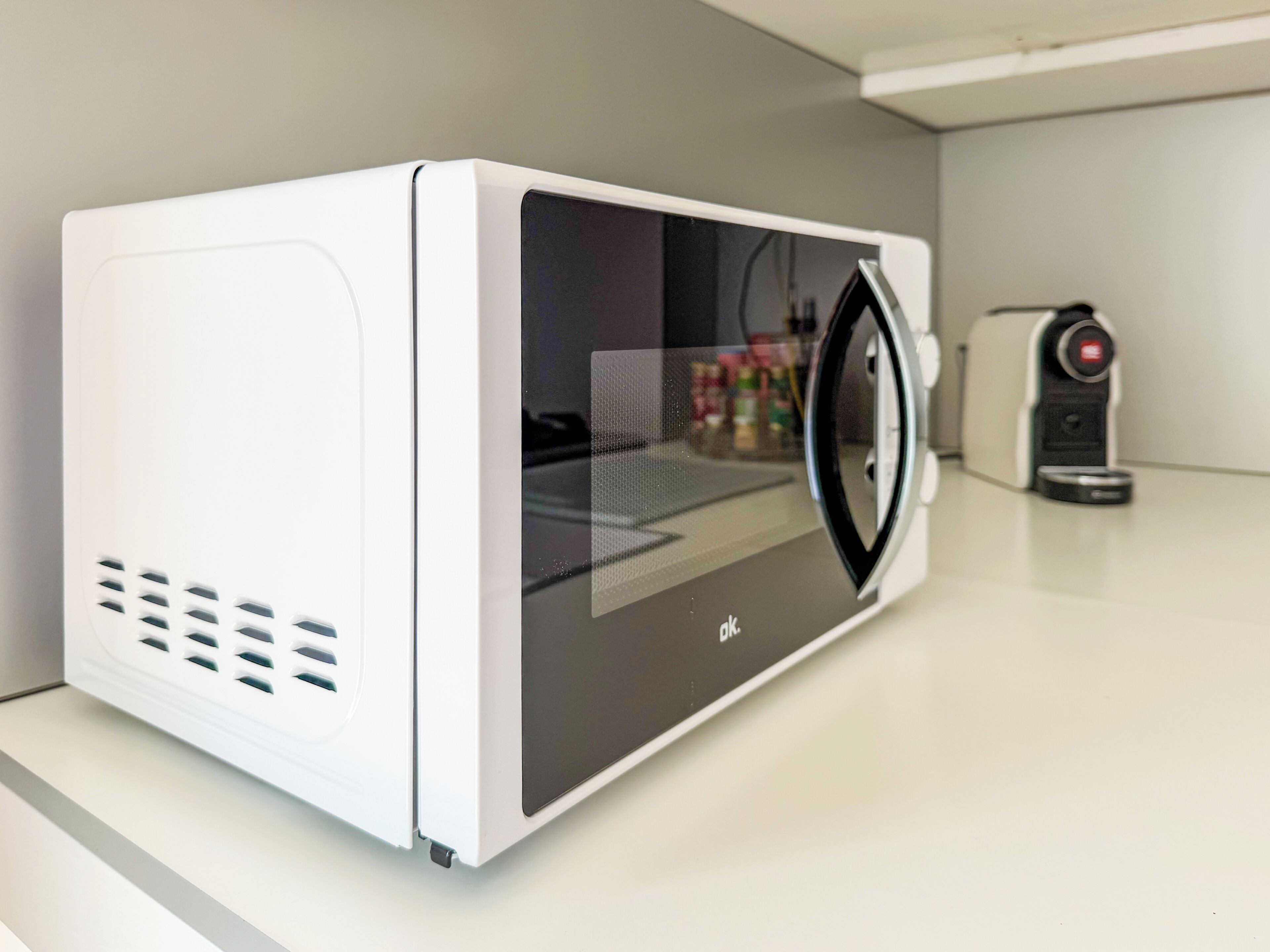 A microwave oven with a digital display, a control panel, and a power button.
