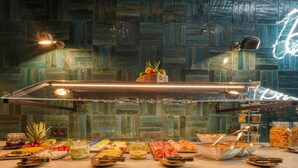 A buffet setup with a variety of food items and a decorative neon sign. - Sunday Hotel Bonn Standard Room (Bonn)